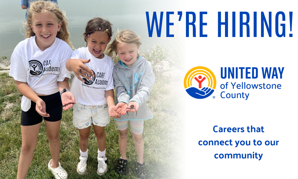 Three girls smile while holding worms and laughing during a fishing field trip